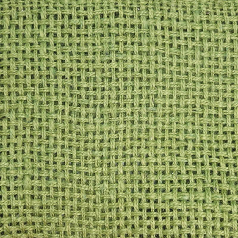 alt="Closer details of a textured green jute design with playful fringe ends."