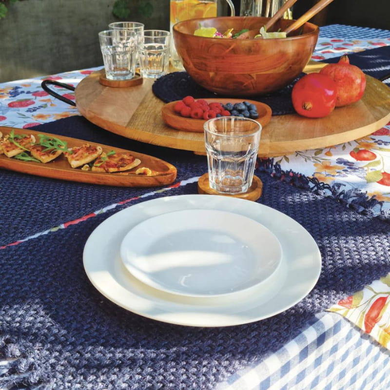 alt="Closer look of a navy jute design with playful fringe ends in a beautiful table setting."