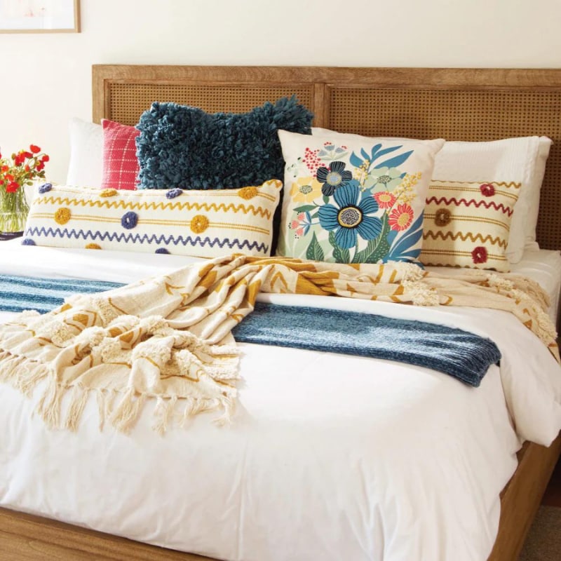 "A red and cream check pattern cushion pairs with other collections of chic companion pillows."
