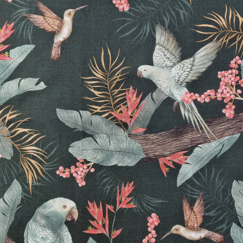alt="Close up look of a forest and evergreen tea towels with a vibrant array of tropical birds surrounded by lush foliage"