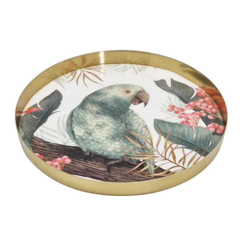 alt="A round serving tray with a tropical design featuring a bird resting on a tree branch laid down"