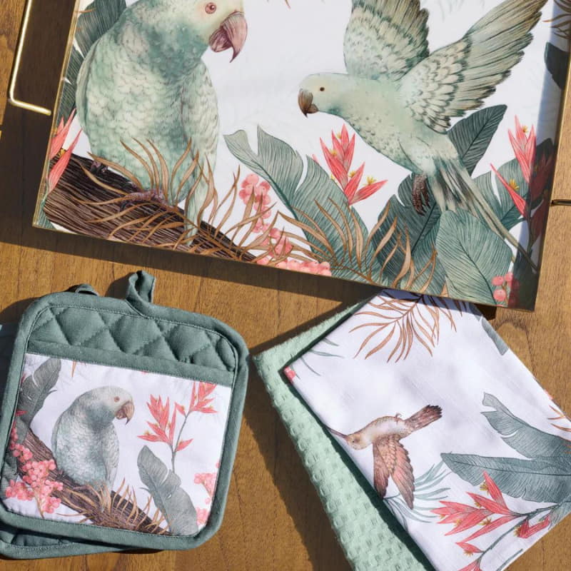 alt="A Tropical tray, pot holder and a cloth designed with images of birds and plants."
