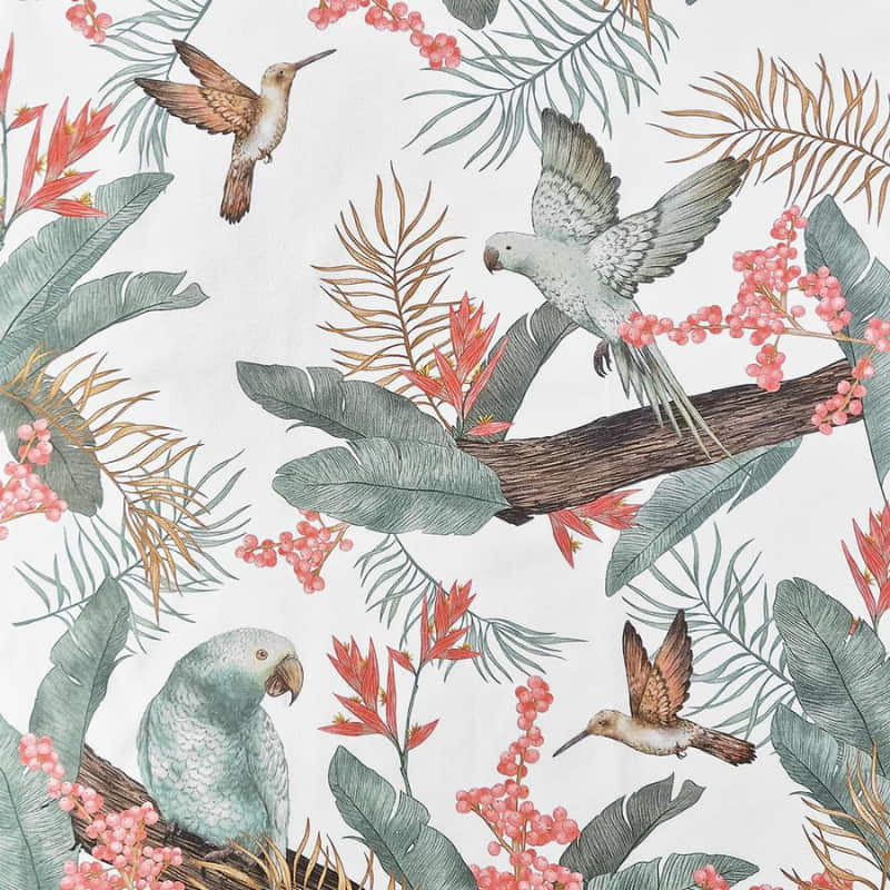 alt="Closer view of a shell pink and coral tea towels with a vibrant array of tropical birds surrounded by lush foliage"