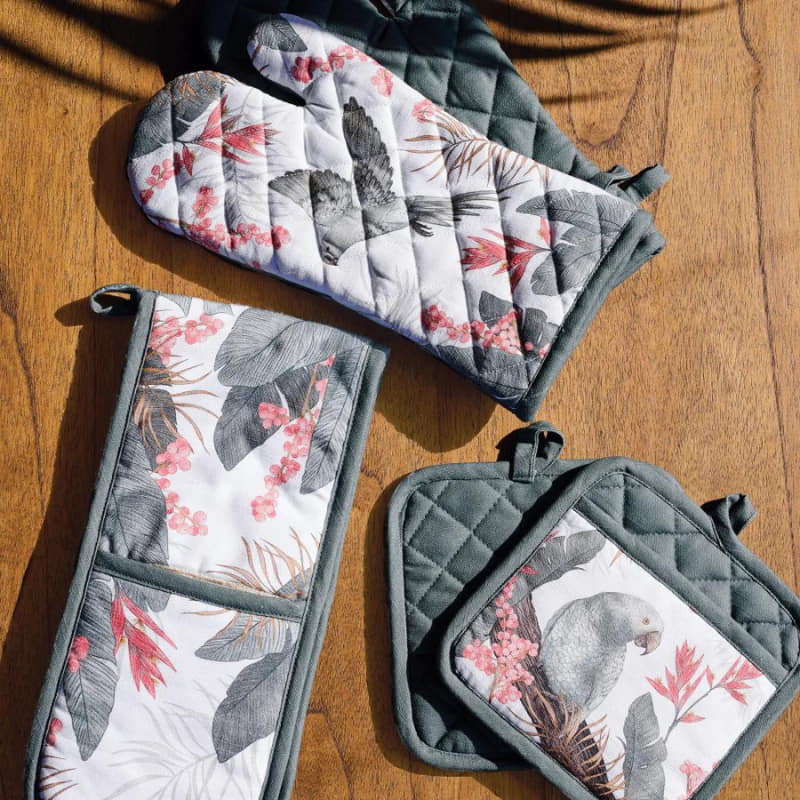 alt="Stunning oven mitts featuring an exclusive hand-drawn tropical bird and foliage design."