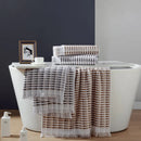 Soft, absorbent cotton towels with modern fringes, enhancing bathroom aesthetics while ensuring comfort after a shower.