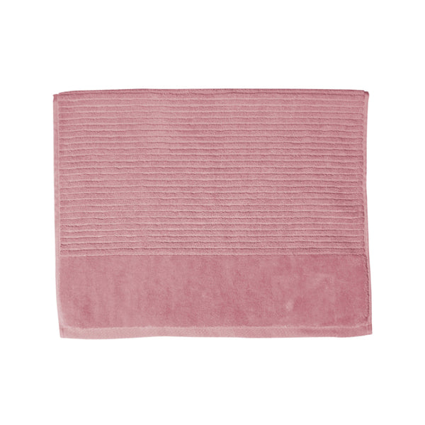 A rosebud bath mat on a white background, highlighting its luxurious feel and vibrant hue, perfect for enhancing bathroom decor.