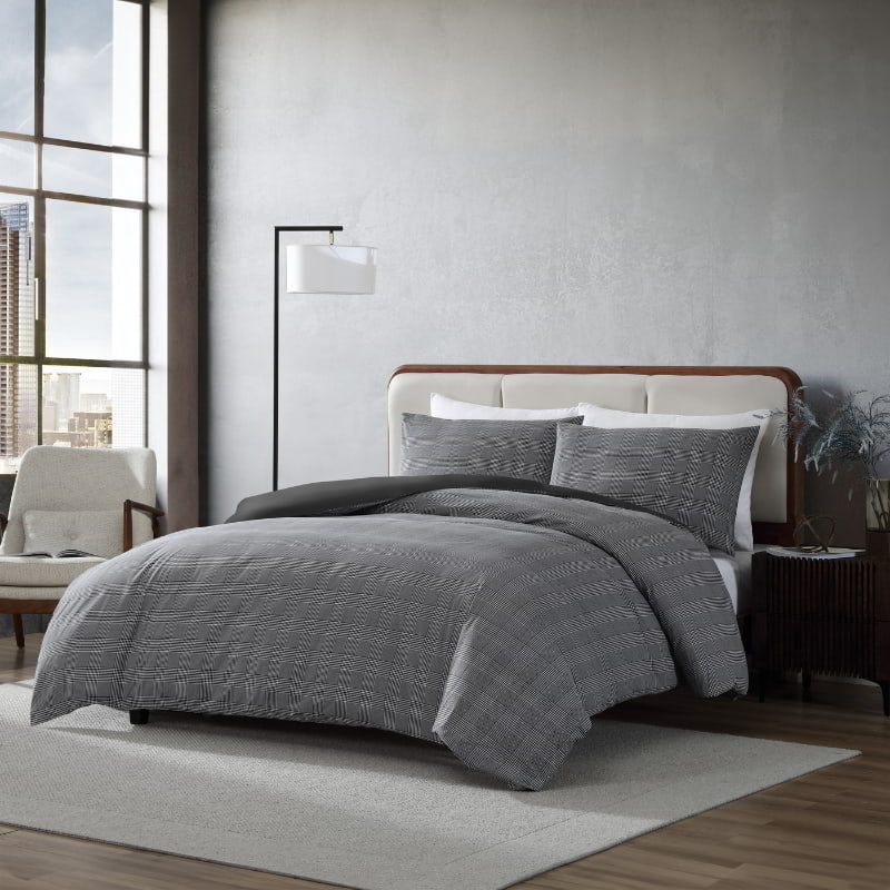 Side view of black and white plaid bedding with matching pillowcases