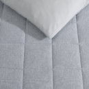 Kenneth Cole quilt cover set folded to show breathable fabric texture