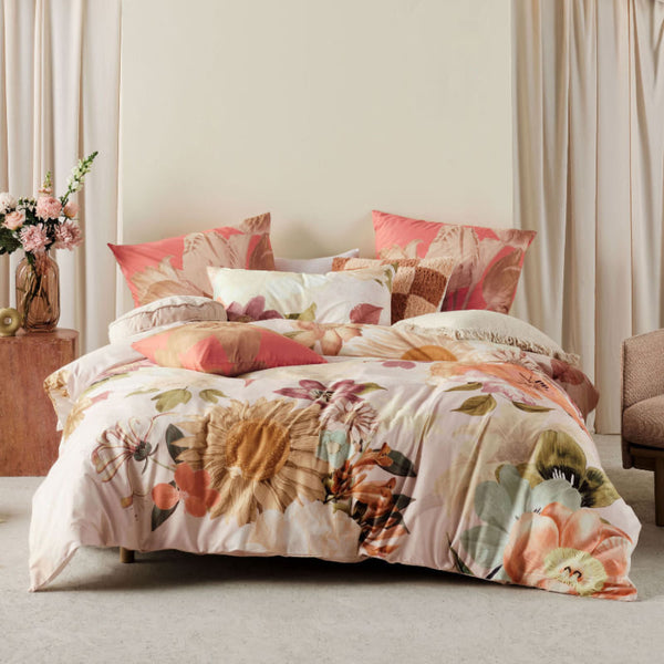 alt="Cotton quilt cover set designed with an archival floral in a luxurious bedroom"