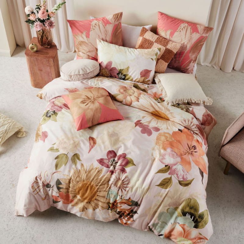 alt="Top shot of cotton quilt cover set designed with an archival floral in a luxurious bedroom"