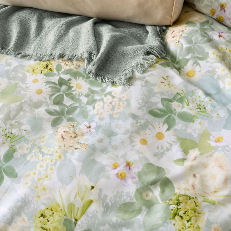 "Showcasing a detailed photographic floral motif quilt cover set in a comfy bedroom"