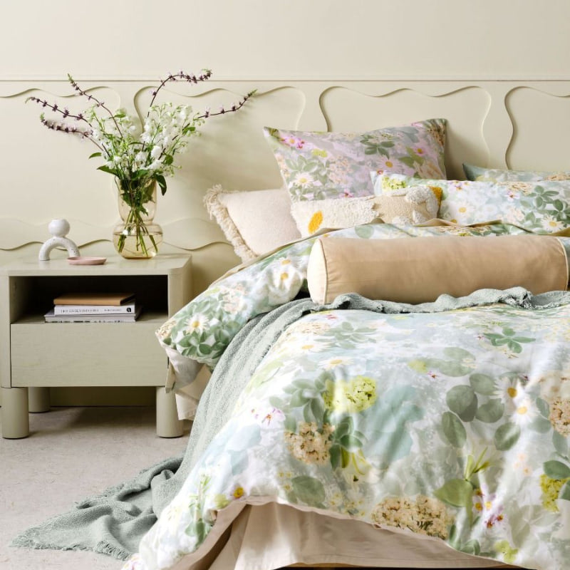 "Closer look of photographic floral motif quilt cover set paired with European pillowcases and tufted cushion in a comfy bedroom"