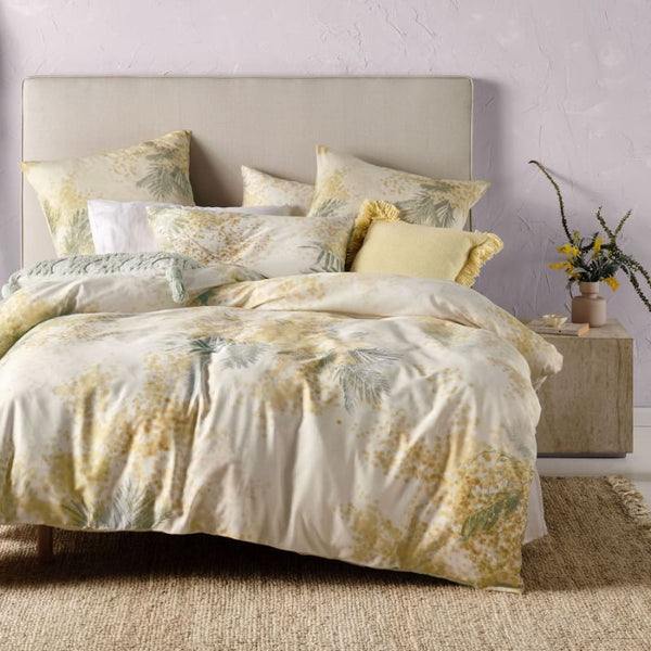alt="A cotton quilt cover set outlined with a golden wattle in bedroom decor"