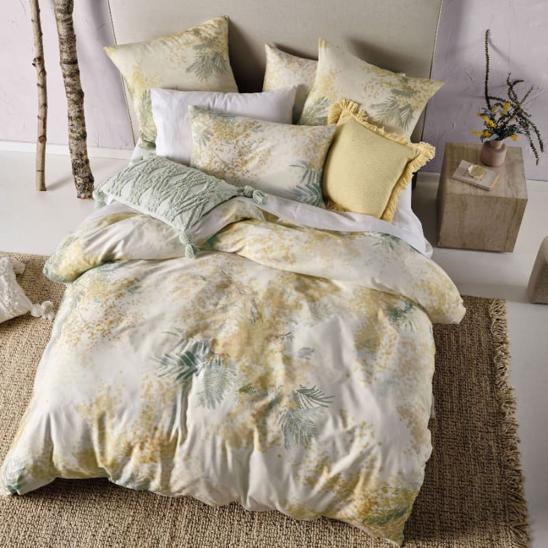 alt="Top view of cotton quilt cover set outlined with a golden wattle pairs with European pillowcases in bedroom decor"
