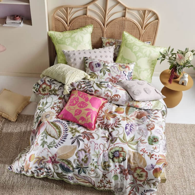 alt="Top view of a hyper-coloured eden of pattern quilt cover set in a luxurious bedroom"