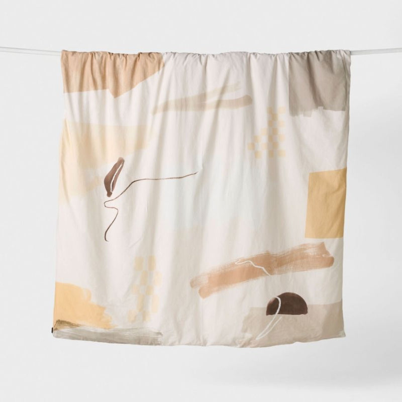 alt="Hanging cotton quilt cover set designed with geometric, gestural shapes"