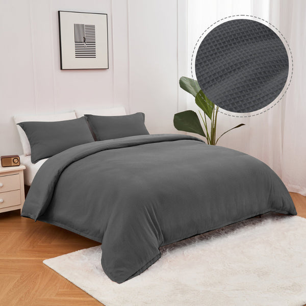 alt="A charcoal quilt cover set features a cotton waffle weave design"