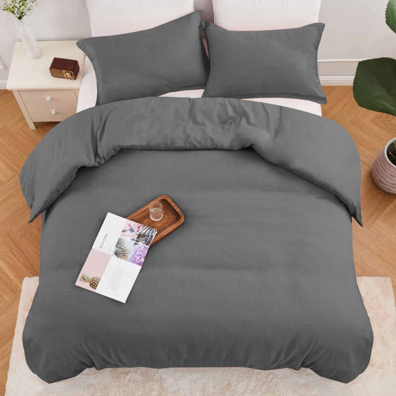 alt="Top view of a charcoal quilt cover set featuring a cotton waffle weave design"