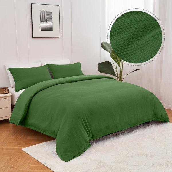alt="A green quilt cover set features a cotton waffle weave design"