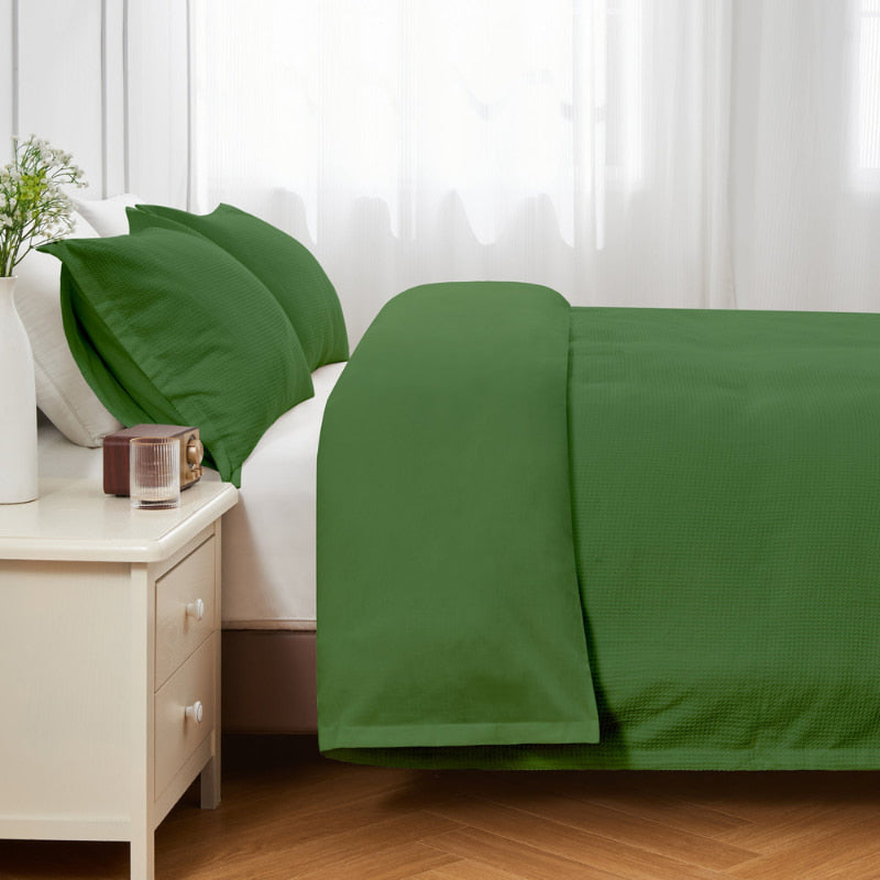 alt="Side view of a green quilt cover set featuring a cotton waffle weave design"