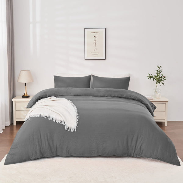 alt="Elegant charcoal quilt cover set displayed on a bed, enhancing bedroom luxury and comfort"