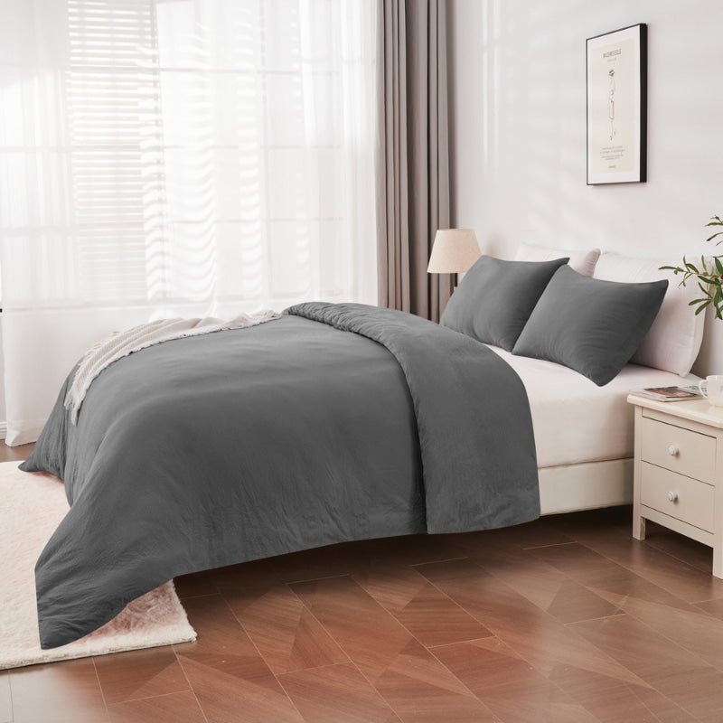 alt="Side view of an elegant charcoal quilt cover set displayed on a bed, enhancing bedroom luxury and comfort"