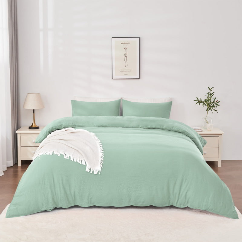 alt="Elegant sage green quilt cover set displayed on a bed, enhancing bedroom luxury and comfort"