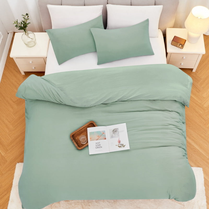 alt="Top view of an elegant sage green quilt cover set displayed on a bed, enhancing bedroom luxury and comfort"