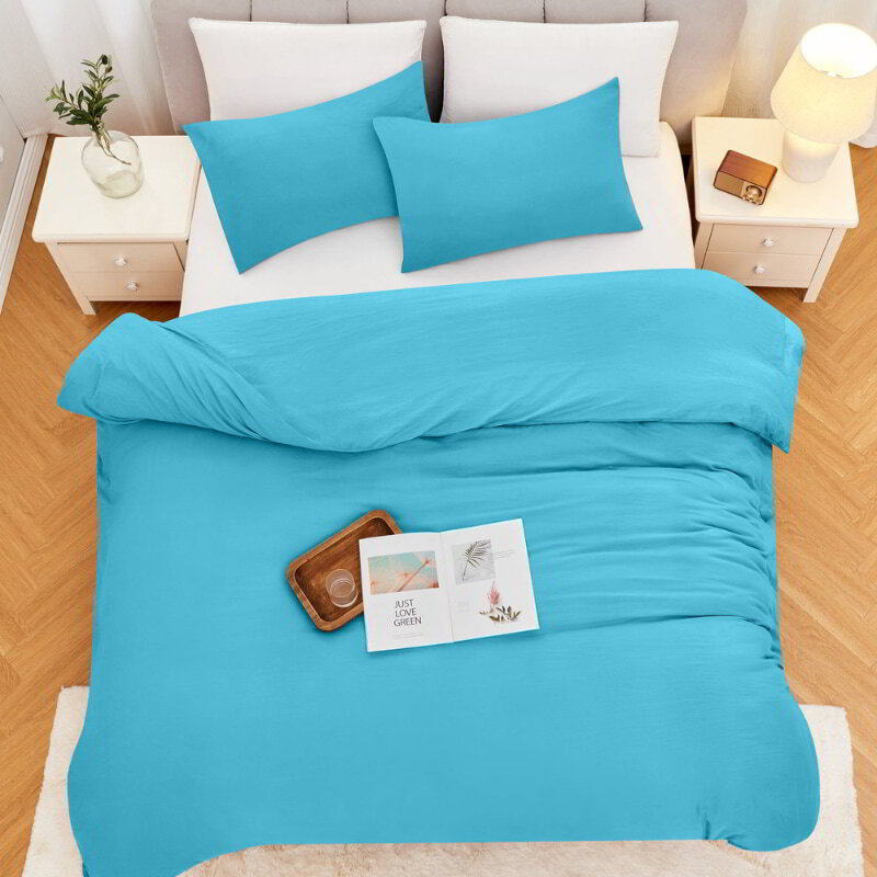 alt="Top view of a blue linenova quilt cover set neatly laid on a bed, showcasing its elegant and soft appearance"