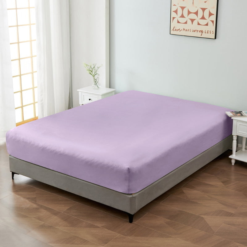 alt="A luxuriously soft 100% cotton lilac fitted sheet with deep pocket in a cosy bedroom"