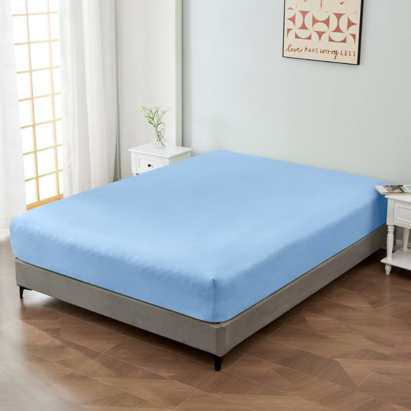 alt="A luxuriously soft 100% cotton light blue fitted sheet with deep pocket in a cosy bedroom"