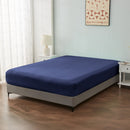 alt="An ultra-soft cotton blend navy fitted sheet with deep pocket in a cosy bedroom"