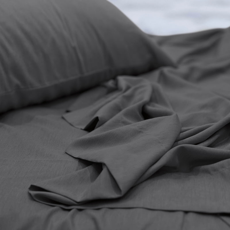 alt="A luxuriously soft to touch bamboo and microfibre blend sheet set in charcoal"