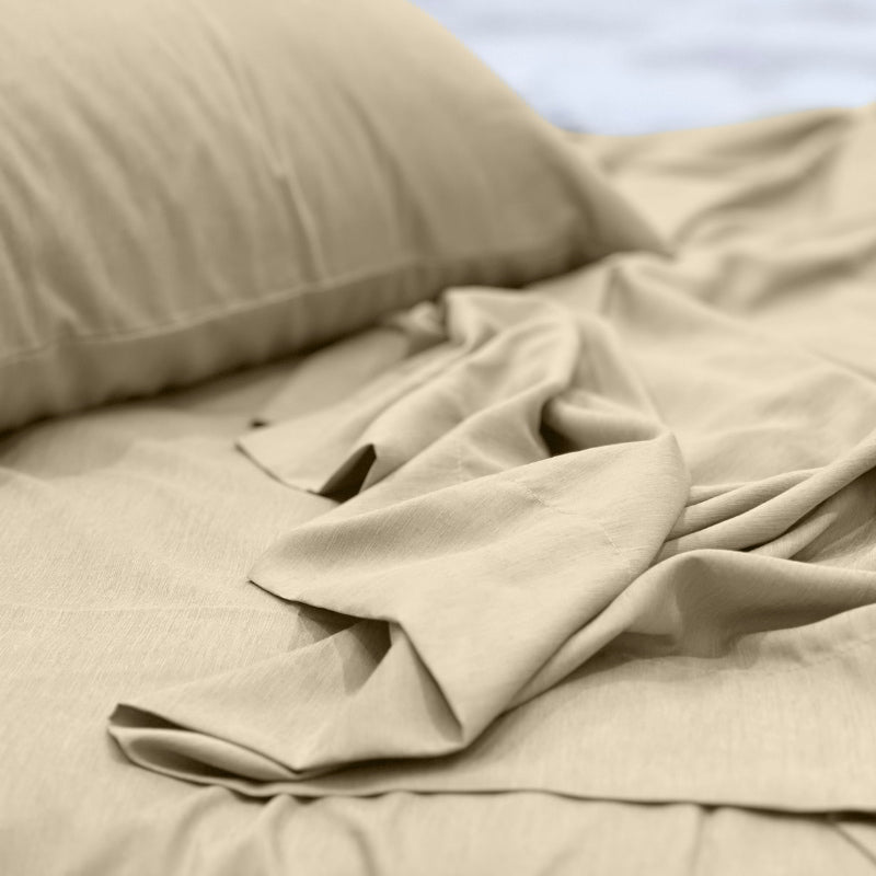 alt="A luxuriously soft to touch bamboo and microfibre blend sheet set in cream"