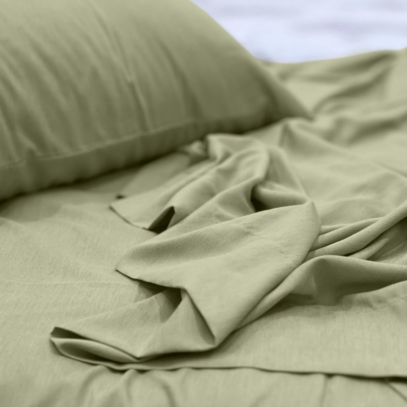 alt="A luxuriously soft to touch bamboo and microfibre blend sheet set in olive green"