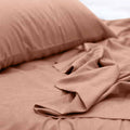 alt="A luxuriously soft to touch bamboo and microfibre blend sheet set in clay"