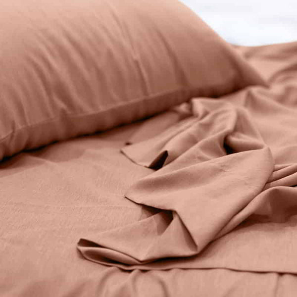 alt="A luxuriously soft to touch bamboo and microfibre blend sheet set in clay"