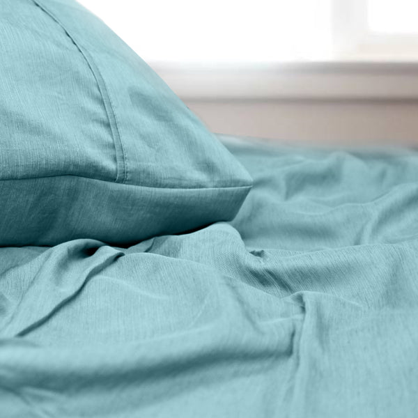 alt="A luxuriously soft to touch bamboo and microfibre blend sheet set in light aqua"