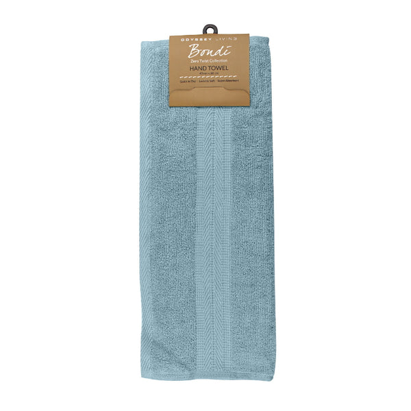 alt="A neatly folded, premium Spa Blue hand towel hanging on a hook, showcasing its minimalistic design and inviting softness."