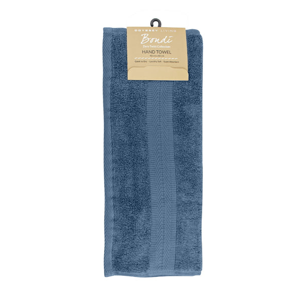 alt="A neatly folded, premium Blue Haze hand towel hanging on a hook, showcasing its minimalistic design and inviting softness."