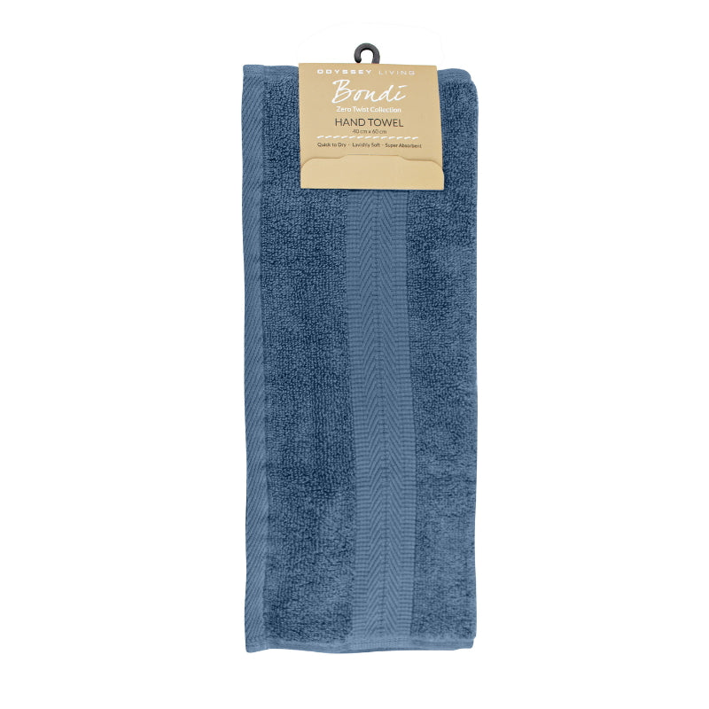 alt="A neatly folded, premium Blue Haze hand towel hanging on a hook, showcasing its minimalistic design and inviting softness."