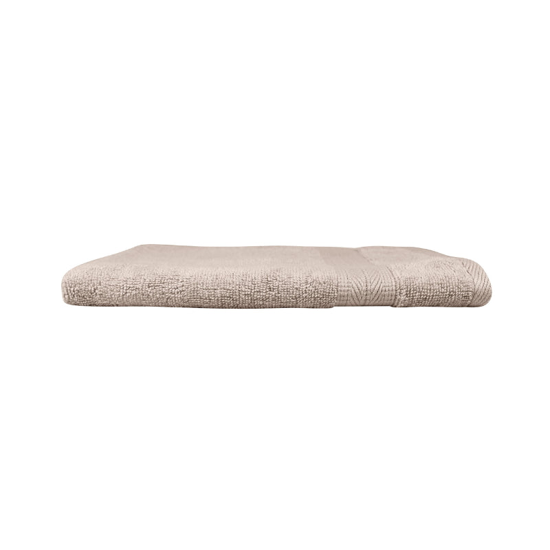 alt="An elegantly folded premium beach colour hand towel, showcasing its minimal and soft details"