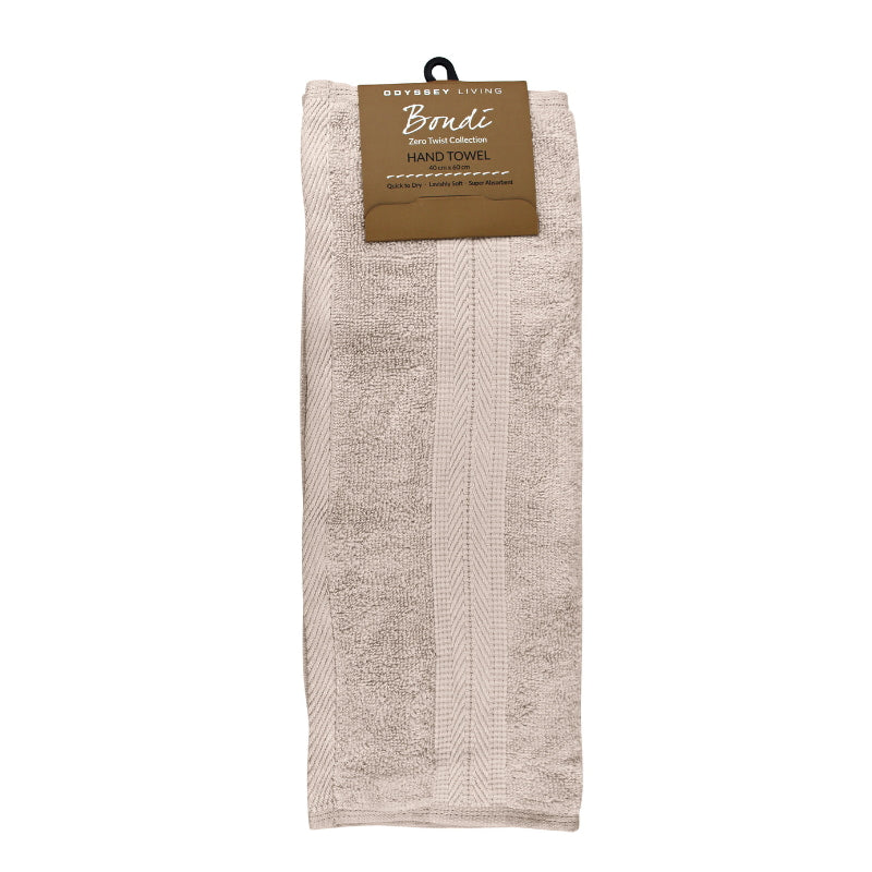 alt="A neatly folded, premium beach hand towel hanging on a hook, showcasing its minimalistic design and inviting softness."