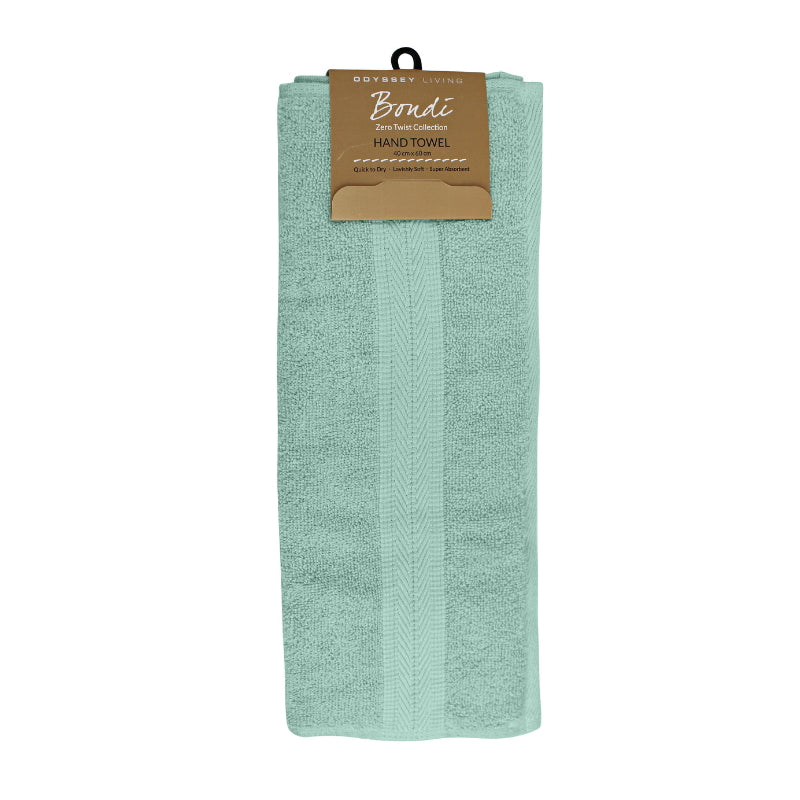alt="A neatly folded, premium dusty sea hand towel hanging on a hook, showcasing its minimalistic design and inviting softness."