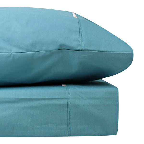 alt="Close-up look of a teal sheet set made from 100% cotton showcasing fresh appearance, ultimate softness and cottony comfort"