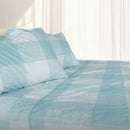 Cornwall sheet set in sky hues neatly layered on a bed for a winter-ready look
