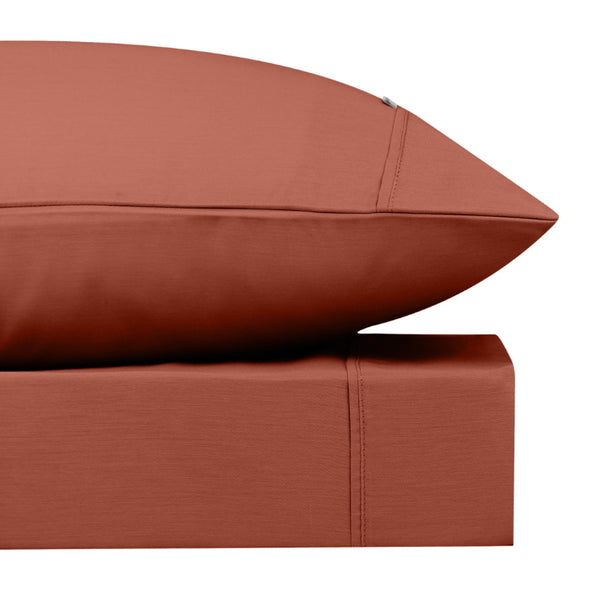 alt="Close-up look of a rust sheet set featuring its softness cotton and durability of polyester comfort for a restful night's sleep"