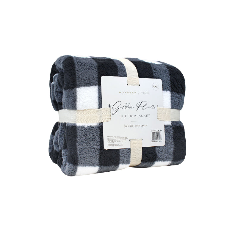 Side packaging details of a cosy bed with a charcoal and white blanket featuring a large checkered pattern creates a bold visual grid, adding colour and pattern to the room's decor.
