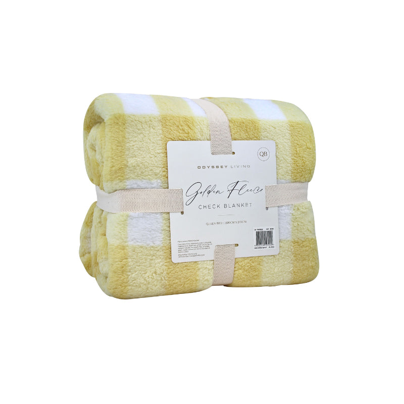 Side packaging details of a cosy bed with a yellow and white blanket featuring a large checkered pattern creates a bold visual grid, adding colour and pattern to the room's decor.