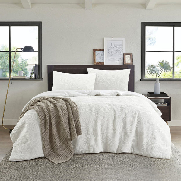 The Haleiwa quilt cover set showcases a textured palm leaf pattern, bringing a serene beach vibe to your sleeping space.